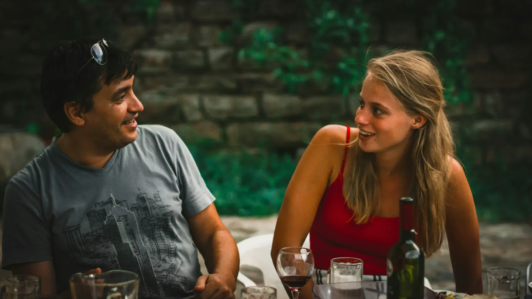 Two guests talking over dinner outdoors